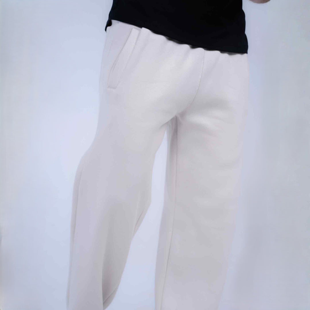 White wide-leg trousers shown on a model from the waist down, paired with a black top against a plain white background.
#color_cloud-dancer